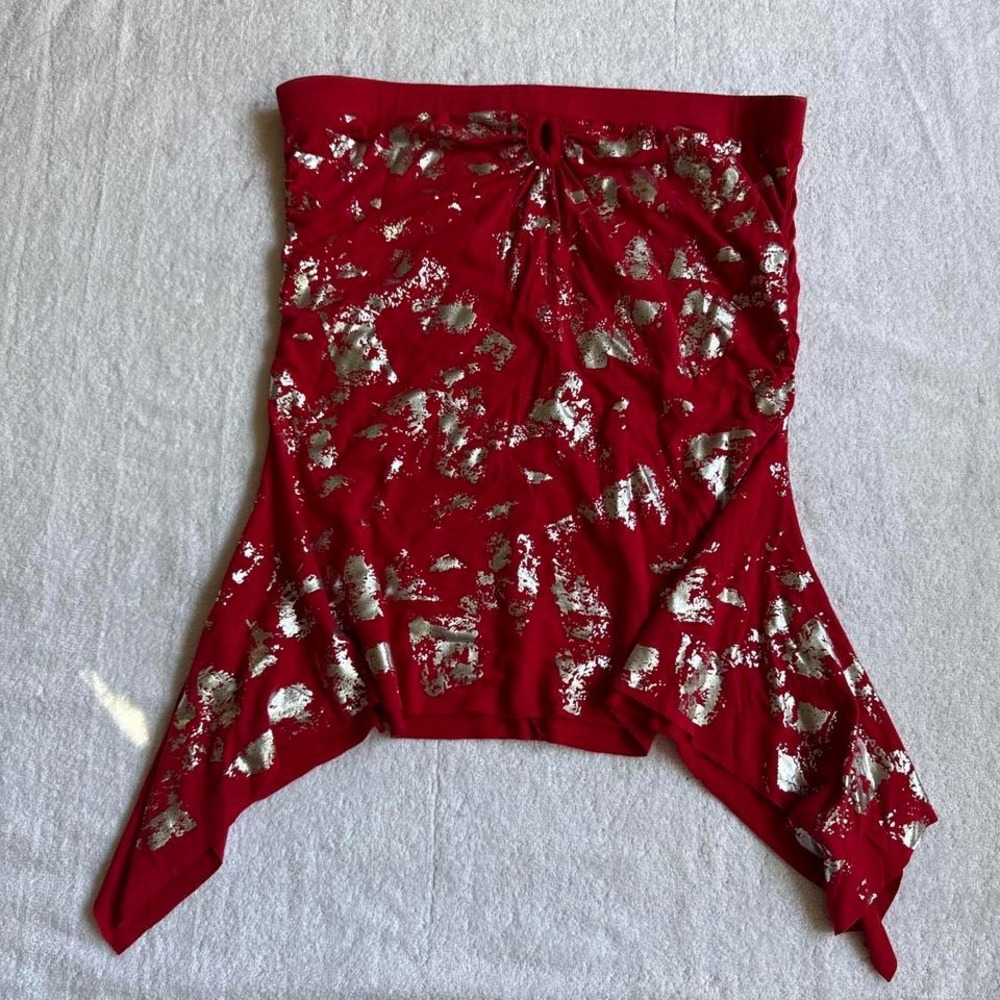 red and metallic tube top with asymmetrical sides and a small hole in the top